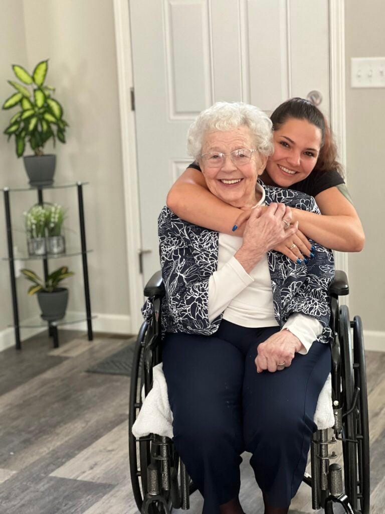 elderly-woman-wheelchair-with-caregiver